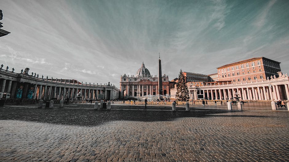 Panoramic view of St. Peter's Basilica and St. Peter's Square in Vatican City on a clear day.